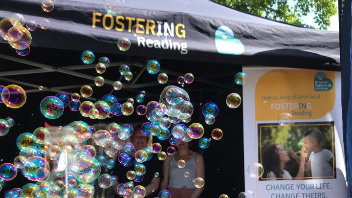 A picture of fostering gazebo with pull up banner and lots of bubbles