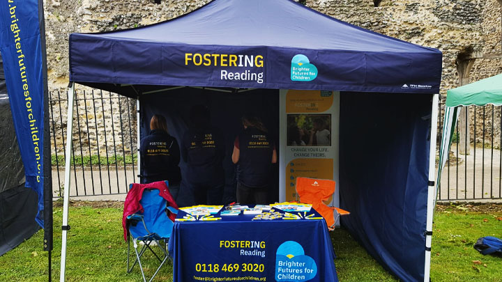 Fostering gazebo with banner stand and table full of information