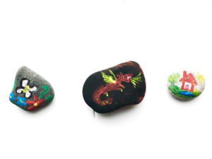 Picture of three pebbles painted by child