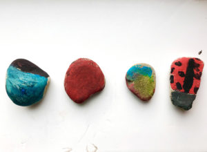 Picture of four pebbles painted by child