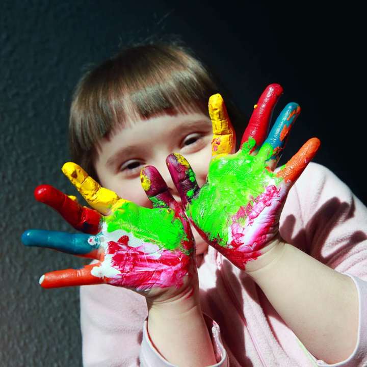 Girl with Down's syndrome with painted hands