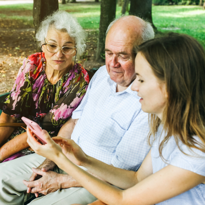 Teenager sitting on park bench with foster carers