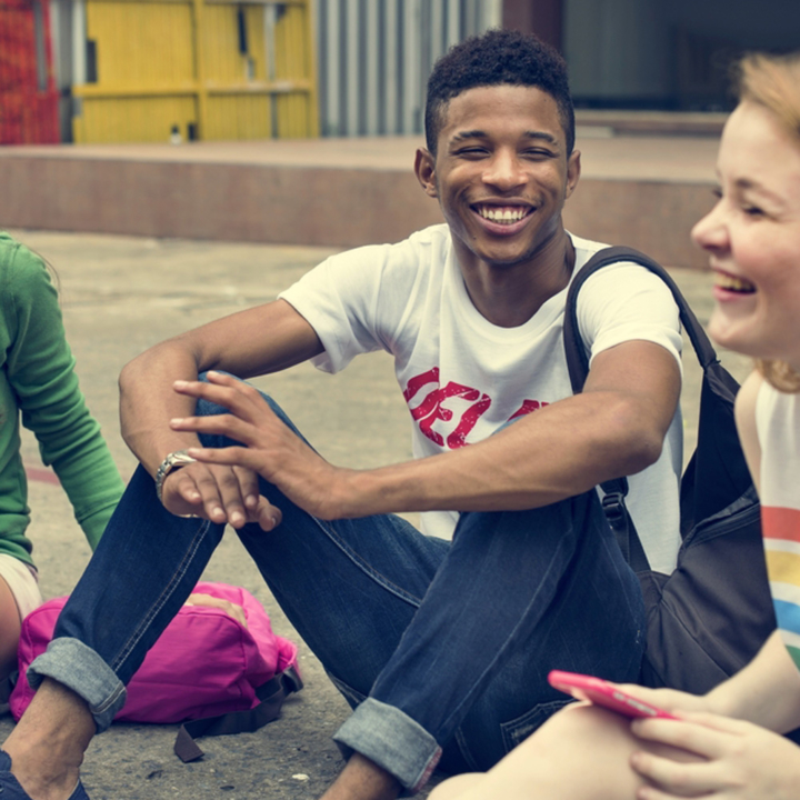 Teenage boy laughing with friends