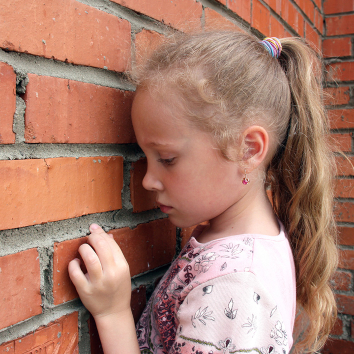 Anxious girl looking at wall